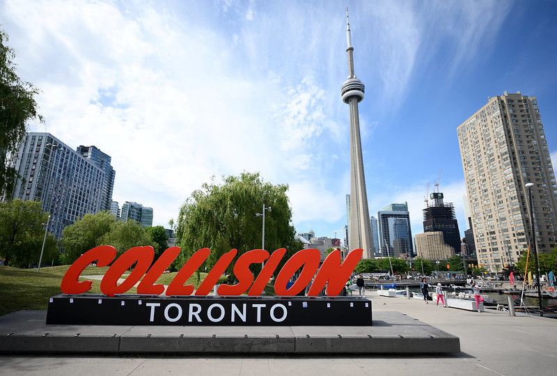 Collision Toronto sign in front of the CN Tower